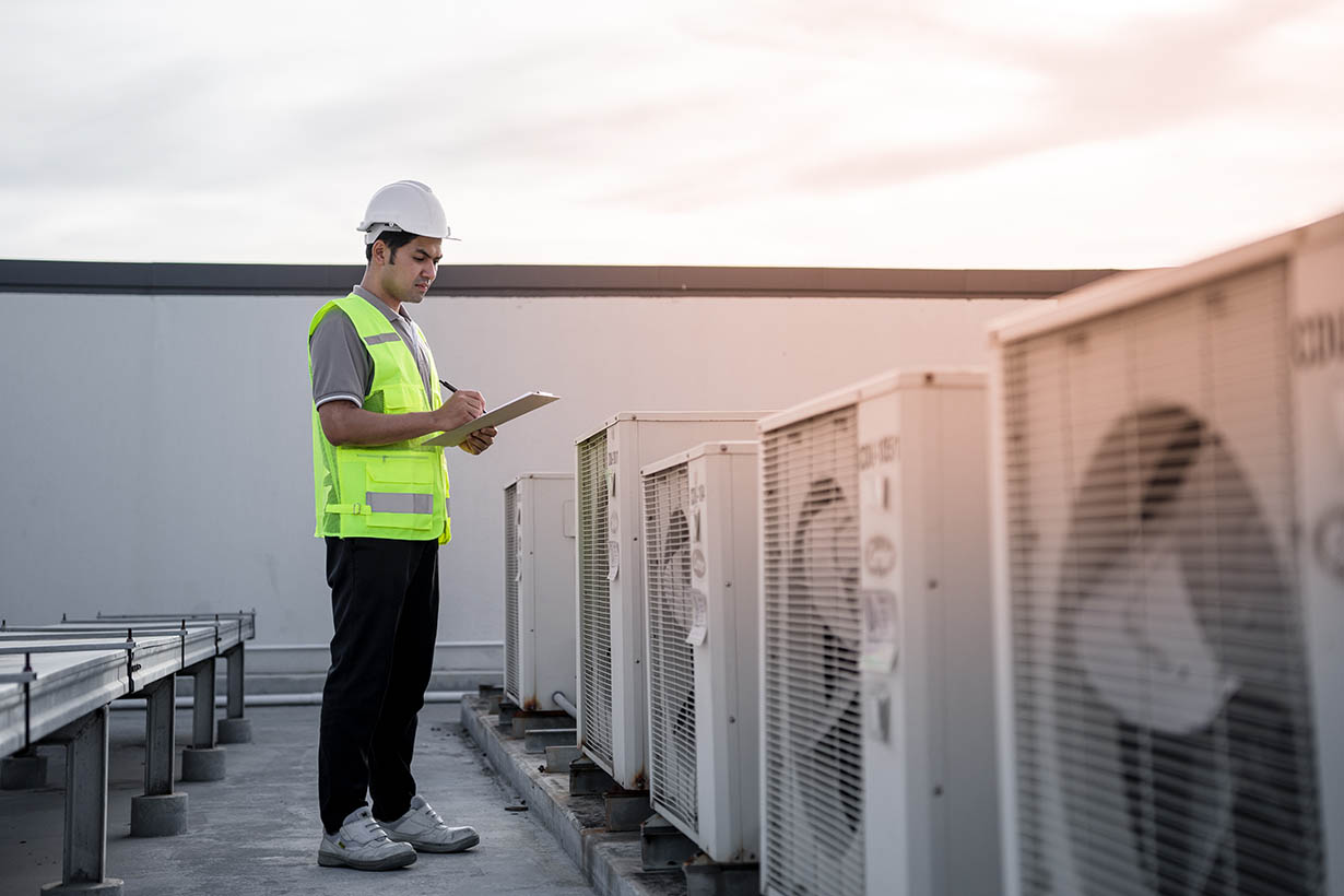commercial HVAC technician performing service