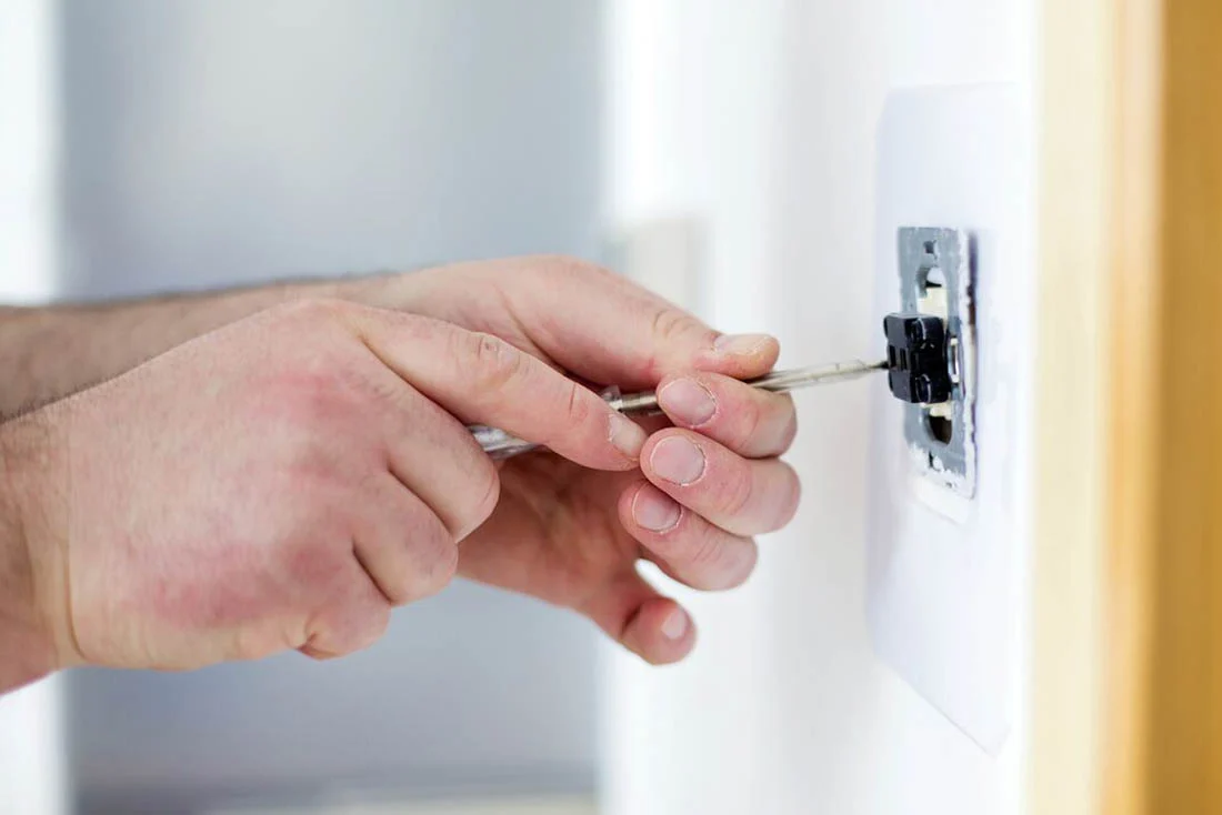 electric-HouseWiring-Supporting-1100×734 Electrician repairing a wall outlet