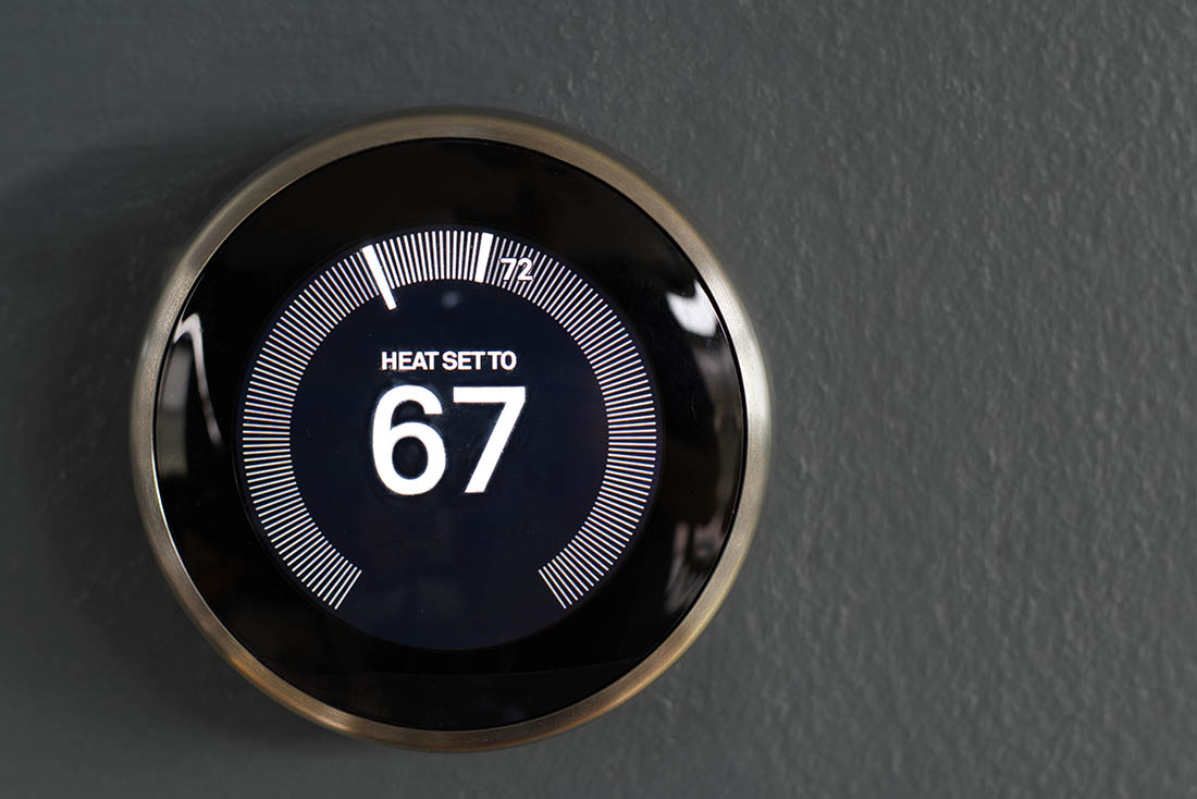 Smart home thermostat from google’s nest. Green tech saving heat smart thermostat set to 67 degrees