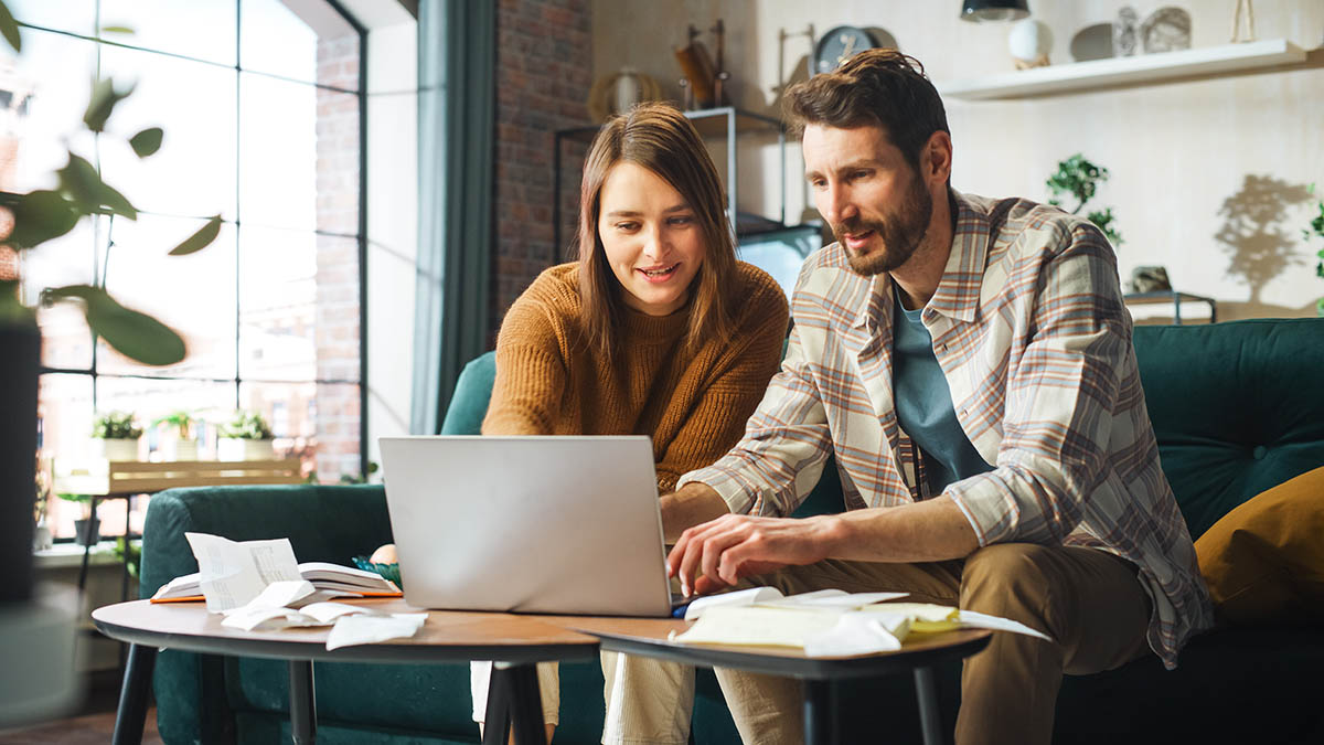 Doing Accounting at Home: Happy Couple Using Laptop Computer,
